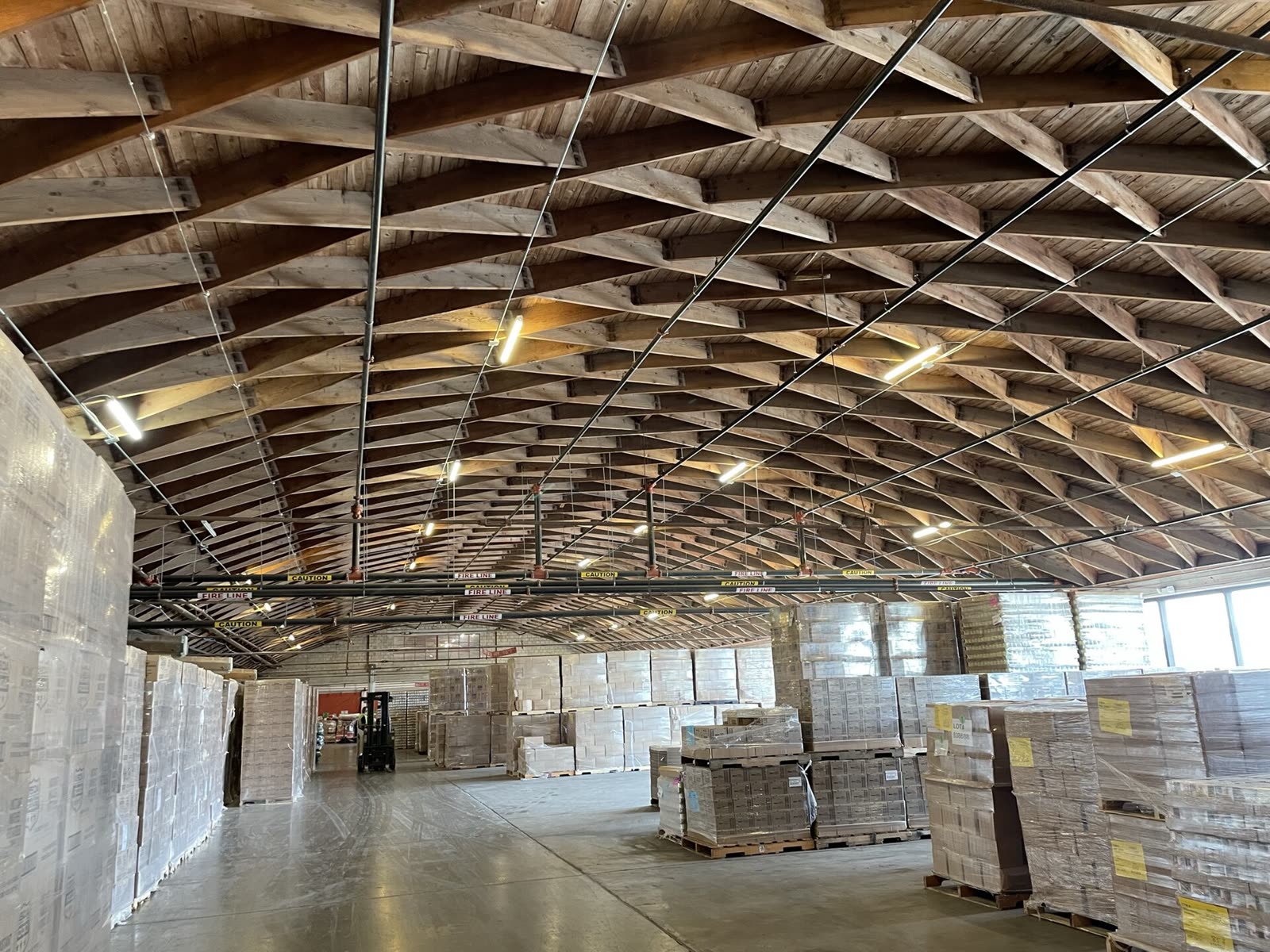 Rows of pallets of food in a warehouse